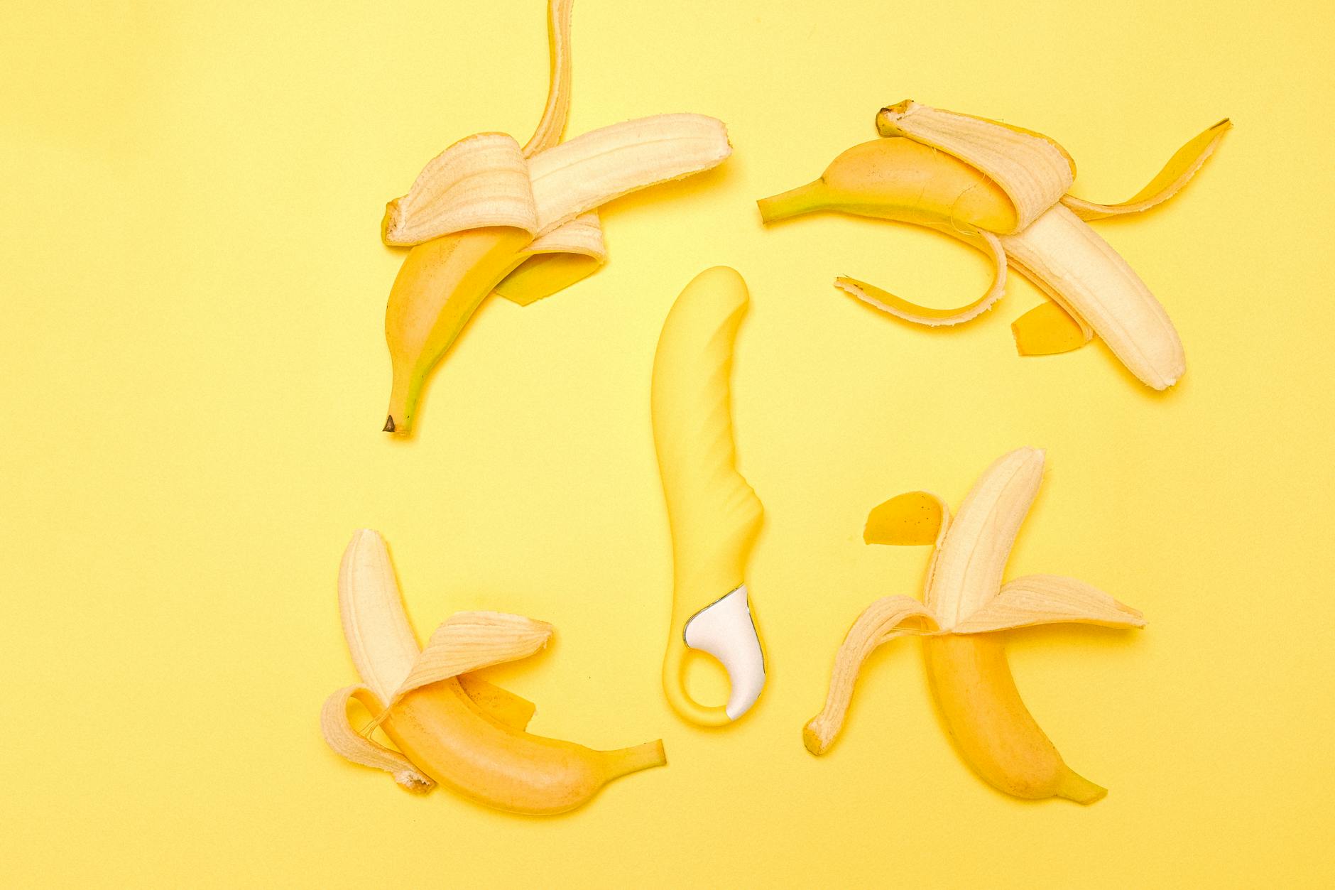 Yellow silicone lemon vibrator on a soft surface, representing gentle post-recovery pleasure