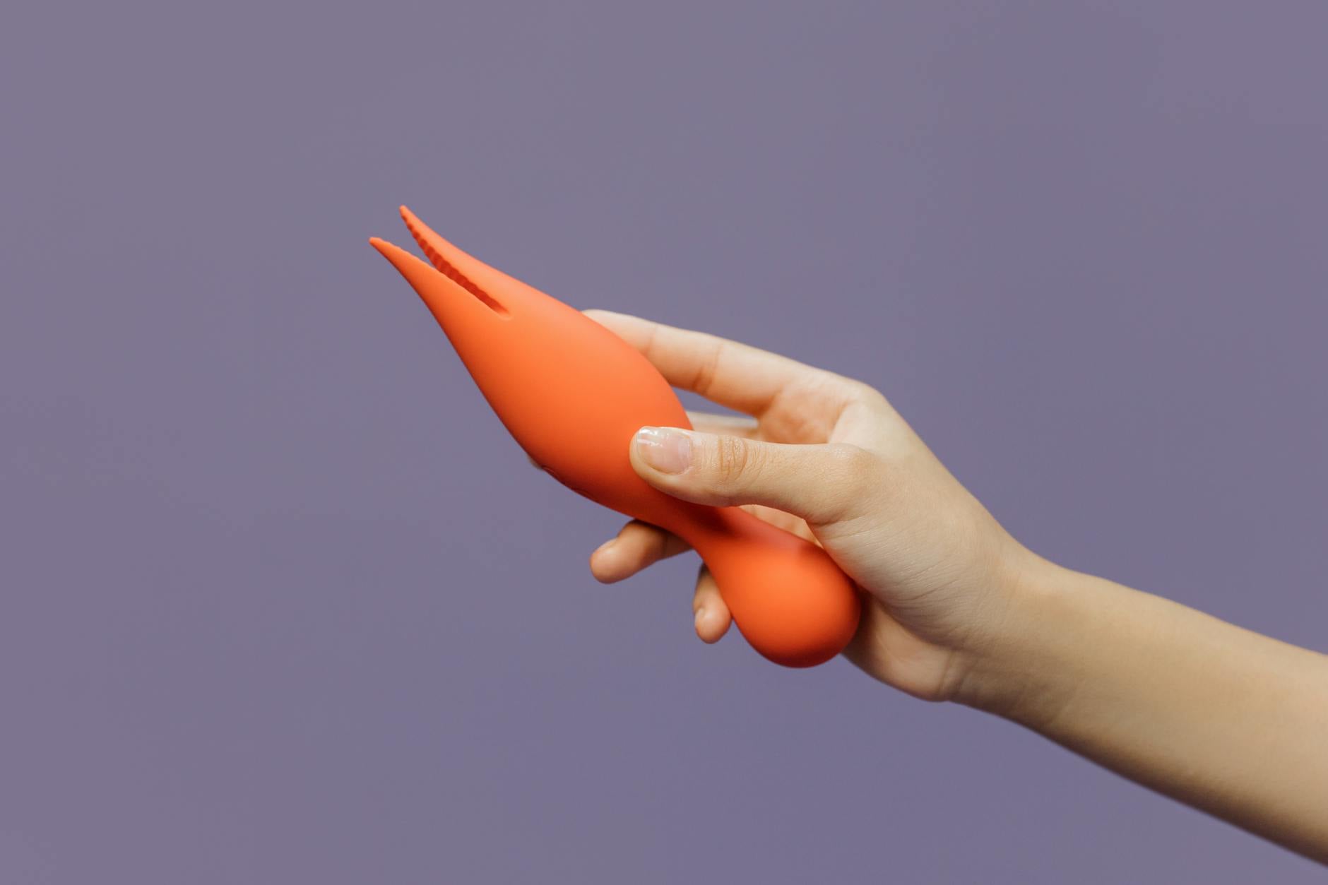 A vibrant lemon clitoral vibrator held in hand, symbolizing modern sensuality and rekindled desire.