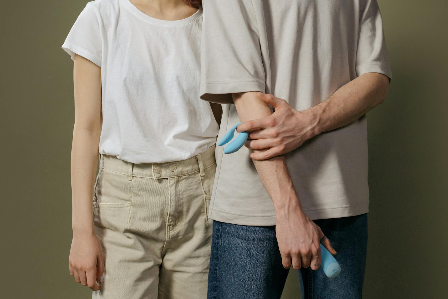 A young couple holding a lemon clitoral vibrator together, representing modern intimacy and exploration