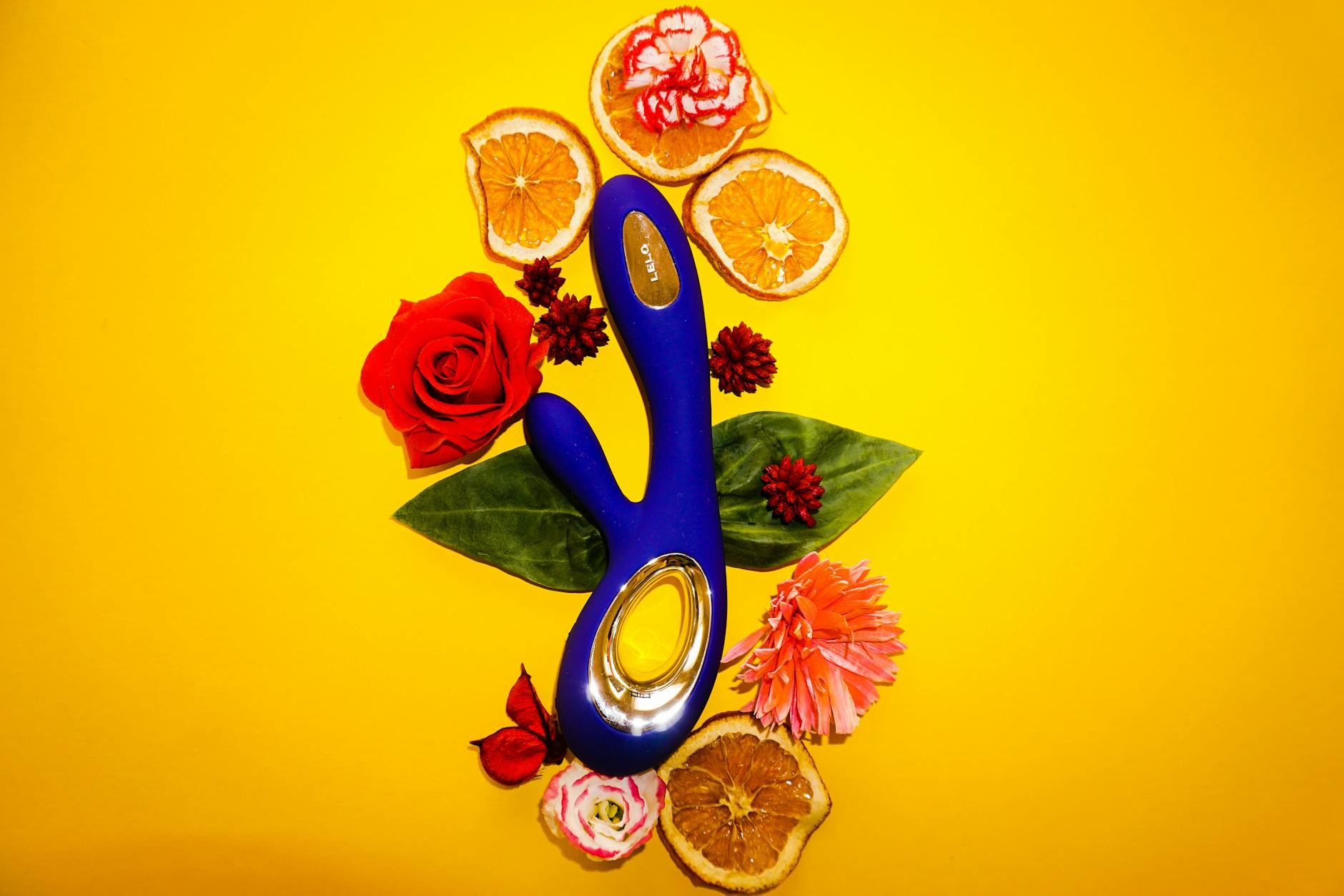 Two hands holding a blue clitoral vibrator together, symbolizing partnered exploration and shared intimacy.
